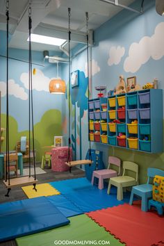 Colorful children's playroom with swings, a vibrant mural of clouds, and organized storage bins filled with toys. The room features soft flooring and various seating options for kids. Indoor Play Place Ideas, Dream Playroom Kids, Small Kids Play Area, Indoor Soft Play Area, Indoor Playroom Business, Smart Playroom, Kids Play Area In Living Room