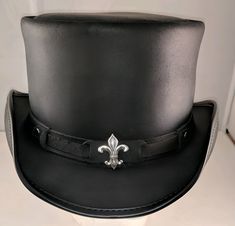 Hand Crafted Leather Premium Quality Leather Hat , Each Hat is Hand made  Description: we have multiple options in leather Color : Black , Dark Brown , Distress Brown , White , Silver , Maroon Redish  , Greenish Green ,  Tan Brown * High-Quality Craftsmanship handmade * Real Leather * 100% pure leather Sizing: XS 54 CM S 55-56 CM M 57-58 CM L 59 CM XL 60 CM XXL 61-62 CM Heads come in all sizes, and in a lots variety of shapes. Although high quality hats are adaptable, and will usually conform to differences in shape with a little wearing, it is essential that the size be correct for the head. To determine your hat size, measure the circumference around your head, keeping the tape level and firm, across the temples and above the eyebrow ridges. Check the size chart given below. For in-betwe Black Leather Hat, Leather Top Hat, Steampunk Top, Steampunk Top Hat, Victorian Hats, Steampunk Hat, Black Leather Top, Leather Hat, Black Crown