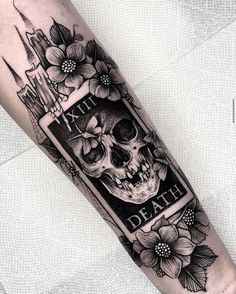 a black and white tattoo with a skull on it