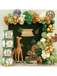 an animal themed baby shower with jungle animals and balloons on the wall, including giraffes