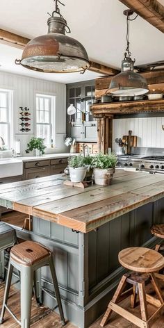 a large kitchen with an island in the middle and two stools at the end