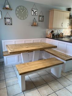 a kitchen with two benches and a clock on the wall