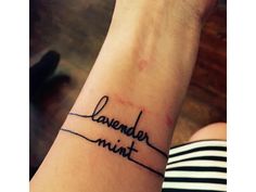 a wrist tattoo with the word lavender mint on it