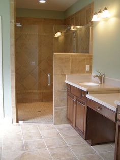 a bathroom with a walk in shower next to a sink