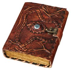 a leather book with an eye on the front and bottom cover is made out of wood