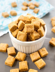 a white bowl filled with sugar cubes on top of a table