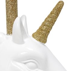 a white unicorn head with gold glitter on it