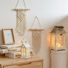 a small table with a lamp and some pictures on it next to a white toilet