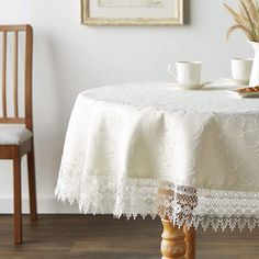 a white table with two cups on it