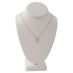 Add the perfect finishing touch to any outfit with this delicate cross motif necklace by Time and Tru. This classic style has genuine cubic zirconia stones and sparkles and shines alone, or is a perfect addition to a layered look. Size: one size.  Color: Gold.  Gender: female.  Age Group: adult. Gold Cross Pendant Necklace For Memorials, Tarnish-resistant Yellow Gold Cross Necklace, Elegant Gold-tone Cross Necklace, Elegant 14k Gold-filled Cross Pendant Necklace, Yellow Gold Crucifix Cross Necklace, Gold Plated, Layered Look, Womens Watches, Cross Necklace, Gender Female