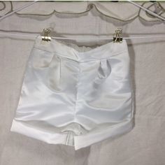 a pair of white shorts hanging on a clothes line