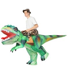 a man riding on the back of a dinosaur costume