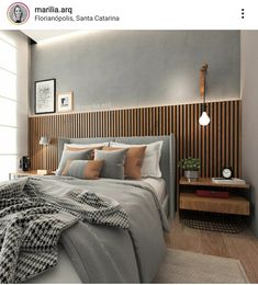 a bed sitting in a bedroom next to a wooden headboard on a white wall