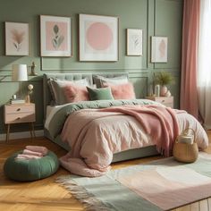 a bedroom with green walls, pink and grey bedding and pictures on the wall