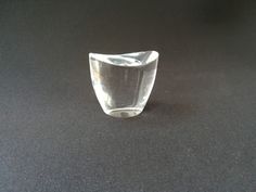 a glass vase sitting on top of a black table