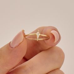 The Diamond Rhombus Ring is a delicate and minimalist piece of fine jewelry available in your choice of 14k, 10k, or 18k solid gold. Its unique rhombus (kite) shape sets it apart from traditional engagement and promise rings, making it a symbol of your distinctive style and individuality. The ring can be made with yellow, rose, or white gold, please choose your size from the dropdown menu options above. 𝐑𝐢𝐧𝐠 𝐃𝐞𝐭𝐚𝐢𝐥𝐬: ❥ Solid gold, available in 10, 14 & 18 karats. ❥ Gold Color Options: Minimalist Marquise Diamond Ring For Gift, Minimalist Marquise Diamond Ring Gift, Minimalist Marquise Diamond Ring, Minimalist Marquise Stackable Rings For Anniversary, Minimalist Marquise Cut Stackable Rings For Anniversary, Dainty Marquise Diamond Promise Ring, Delicate 14k Gold Marquise Cut Ring, Delicate 14k Gold Marquise Diamond Ring, Delicate Marquise Diamond Ring In 14k Gold