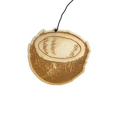 a wooden ornament with an image of a coconut