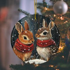 an ornament with two rabbits wearing scarves