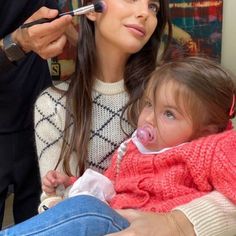 a woman blow drying her daughter's hair