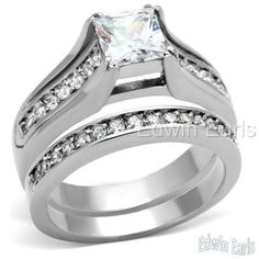 a white gold wedding ring set with a princess cut diamond in the center and side stones