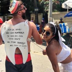 a man and woman dressed up as toothpaste on the side of the road