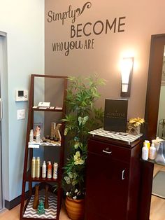 a salon with a large sign on the wall above it that says simply become who you are