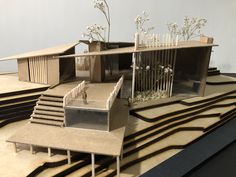 an architectural model of a house with flowers growing out of the roof