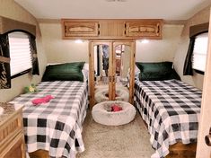 two beds in a trailer with black and white checkered sheets