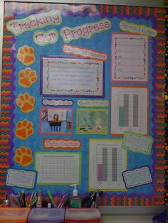 a bulletin board with writing and pictures on the front, along with other school supplies