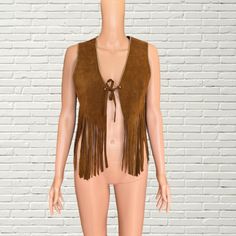 Vintage 60s - 70's Tan Beaded Suede Fringe Vest Boho Western style cropped length vest  tan brown suede leather fabric  Gold beaded trim  front tie closure  Brand: Mr Leather good condition, some general wear as pictured Measurements: Length: 22" Pit to pit: 18" Hippie Style Vest For Fall Festival, Fall Festival Vest With Fringe, Bohemian Fringe Vest For Festivals, Western Style Brown Vest For Fall, Western Brown Vest For Fall, Brown Western Vest For Fall, Bohemian Fringe Vest, Fitted Fringe Vest, Fitted Fringe Vest For Festival