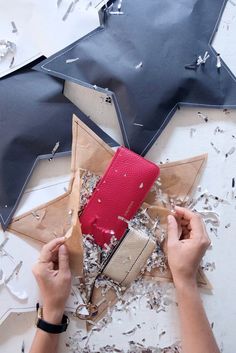 a person holding a red purse in front of a star shaped object