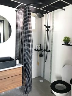 a black and white bathroom with a shower