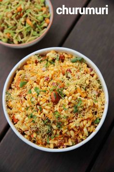 two bowls filled with food sitting on top of a wooden table next to each other