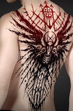 the back of a man's body with tattoos on his chest and wings painted on it