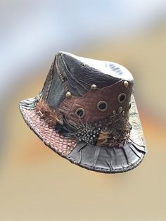 Handmade patchwork studded brown leather Fedora hat One of a kind item made with ❤️ and passion & patience Out of recycled leather,great textures and structures reptile-print,different shades of brown handstitched details Decorated with old copper rivets & eyelets sculpted leather Feathered band. polyester lining A real eye-catcher Pimp up any outfit or protect youself from the sun on a warm day with this unique hat.! Size 58 cm/22,8 Inches border 4 cm/1.57 Inches hight10 cm/3,93Inches Brown Leather Hats For Festivals, Leather Hats For Fall Festival, Leather Brimmed Hat For Festivals, Leather Brimmed Festival Hats, Brown Brimmed Hippie Hat, Leather Bohemian Hats For Festivals, Hippie Brown Hats For Festival, Hippie Brown Hat With Short Brim, Brown Hippie Brimmed Hat