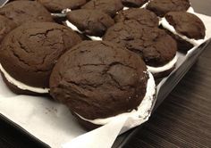 chocolate cookies and marshmallows are on a tray