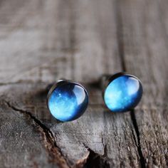 "Beautiful, vivid blue stardust earring studs. Lovely pair of handcrafted earrings featuring a beautiful blue space. Made of 100% hypoallergenic SURGICAL STAINLESS STEEL and RESIN. More SPACE STUD: http://etsy.me/1knzMWx More SPACE: http://etsy.me/1pEAycy More STUD earrings: http://etsy.me/Ym7FfT DIMENSIONS - 7mm / 10 mm / 12 mm (0.27\" / 0.4\" / 0.5\") in diameter MATERIALS - glossy, jewelry grade resin, that makes the earrings durable but light weight, as well as water resistant - high quality Blue Celestial Round Earrings, Blue Celestial Hypoallergenic Jewelry, Blue Celestial Nickel-free Earrings, Blue Round Plug Earrings As Gift, Blue Round Plug Earrings For Gift, Blue Plug Earrings For Gifts, Blue Universe, Moon Earrings Studs, Studs For Men