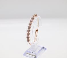 This bracelet is made of rose gold, which is a beautiful and durable material. The bracelet is designed to be worn by women and is available in a variety of sizes to ensure a comfortable fit. The bracelet is adorned with a delicate pattern that adds a touch of elegance to any outfit. Rose Gold Chain Bracelet With Bracelet Strap, Elegant Rose Colored Bracelet Jewelry, Elegant Rose-colored Bracelet Jewelry, Elegant Rose Color Bracelet For Gift, Elegant Rose Colored Bracelet, Adjustable Formal Charm Bangle Bracelet, Adjustable Bangle Charm Bracelet For Formal Occasions, Adjustable Rose Gold Jubilee Diamond Bracelet, Adjustable Charm Bracelet For Formal Occasions