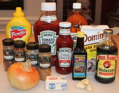 an assortment of condiments and sauces on a counter top, including onions