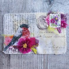 a close up of a piece of fabric with flowers on it and a bird in the middle