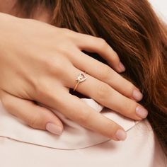 a woman wearing a diamond ring on her finger