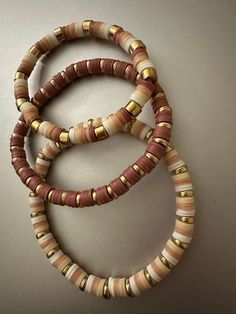 There are many colors of brown with white. These are perfect for any occasion Clay Bead Bracelet Inspo Fall, Aesthetic Clay Beads Ideas, Clay Bead Fall Ideas, Bracelet Patterns With Clay Beads, Silicone Beads Bracelet, School Color Clay Bracelets, Beige Clay Bead Bracelets, Fall Braclets Clay Bead, Clay Bead Bracelet Ideas Aesthetic Brown