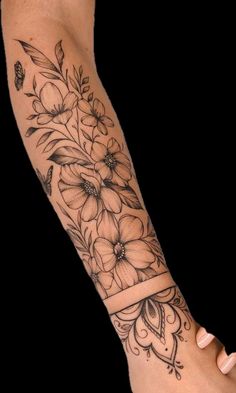 a woman's arm with flowers on it