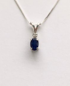 Genuine small dark sapphire measures 6x4mm (1/2 carat). Genuine 2mm accent diamond. Both handset in sterling silver. Sterling silver box chain is 18 inches long and can be switched out to a 16 inch chain upon request.Necklace is perfect for a child or the minimalist. Comes in a gift box Oval Sapphire Diamond Necklace, Sapphire Birthstone Necklace In Lab-created Sapphire, Classic Sapphire Necklaces With Prong Setting, White Gold Necklace With Birthstone And Lab-created Sapphire, Sapphire Birthstone Necklace With Lab-created Sapphire, White Gold Necklace With Lab-created Sapphire Birthstone, Lab-created Sapphire Birthstone Necklace, Silver Sapphire Pendant Diamond Necklace, Sapphire Diamond Cut Pendant Necklace