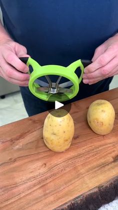 a person cutting potatoes with a pair of scissor glasses on top of them