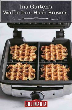 four waffles being cooked in a griddle on a white counter top with black grates