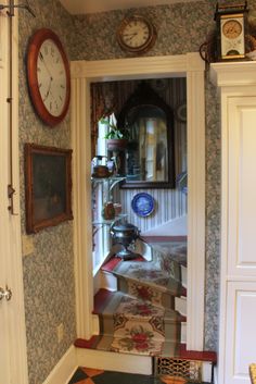 an entry way with several clocks on the wall