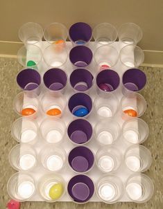 the trays are filled with different colored cups