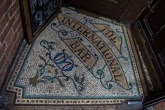 the entrance to an old building with a mosaic floor