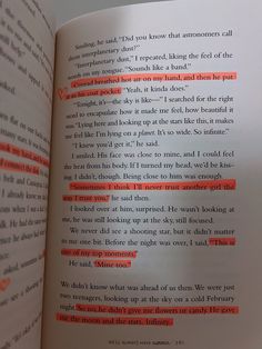 an open book with red text on the page and orange lines in between it's pages